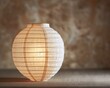 The soft glow of a white paper lantern on a muted background symbolizing gentle light