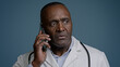 Mature african american man doctor talk on phone with patient close-up puzzled male medical consultant in white coat consult client by smartphone give negative answer say no remote healthcare service