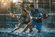 A dynamic duo, a male and female padel team, engage in a spirited game of tennis, showcasing agility, teamwork, and skill.