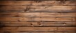 A detailed view showing a wooden wall surface with a rich brown stain applied, creating a warm and rustic texture background