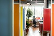 © studioworkstock - open concept office with colorful partitions, one person in the background