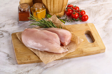 Raw chicken breast served rosemary