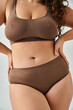 © LIGHTFIELD STUDIOS - cropped shot of body beautiful plus size young woman in underwear posing against grey background