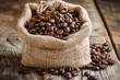 coffee beans in burlap sack on wooden table