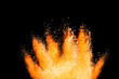 Abstract powder splatted background. orange powder explosion on black background. Colored cloud. Colorful dust explode. Paint Holi