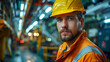 A bearded worker in safety gear stands confidently in an industrial setting, showcasing workplace safety and professionalism.
