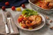 Baked salmon with vegetables on a gray background
