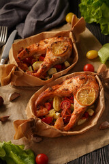 Wall Mural - Baked salmon with vegetables on a dark background