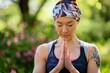 yoga practitioner in a headband meditating outdoors