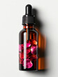 Glass dropper bottle with black rubber head. There are rose petals in the liquid.