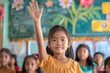 © Igor - A schoolboy is raising his hand in a school classroom