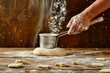hand holding flour sifter dusting dough on wooden table