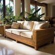 wicker sofa in a sunlit room with tropical plants