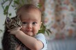 baby holds kitten gently with a look of wonder