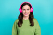 Portrait of cheerful funky person enjoy listen melody playlist toothy smile isolated on teal color background