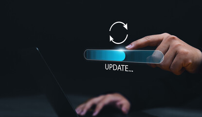 Fototapete - Updating computer system software application installation for devices to be up to date with the new version. Hand interacting with graphics icon updating function screen loading on computer laptop.