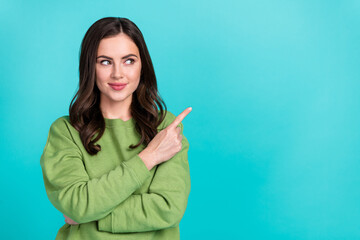 Poster - Photo of friendly positive girl look interested finger direct empty space isolated on turquoise color background