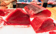 Raw Red Tuna Fish fillet close-up for sashimi or steak at the seafood market. Keto food and healthy nutrition concept.