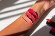 bright matte lipstick swatches on arm in natural daylight