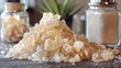 A pile of salt crystals beside a shaker of table salt, crystalline purity