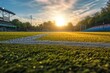 Close up of green turf of soccer field with white line marking at sunset