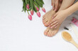 Closeup of woman with neat toenails after pedicure procedure on white terry towel, top view. Space for text