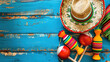 Spectacular Cinco de Mayo holiday background with Mexican party sombrero hat and maracas on blue wood