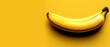   A yellow banana rests atop a yellow table, adjacent to a black focal point in the frame