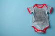 © reddish - Striped Baby Bodysuit With Red Trim on Blue Background
