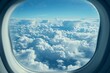 Aerial view of fluffy white clouds from airplane window, ideal for travel agencies and tourism sites