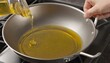 pouring sunflower oil in a pan