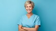 Mature female experienced doctor, healthcare professional, dentist, stomatologist, nurse smiling on a blue background