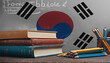 Books with pencils on the background of the Republic of Korea flag. Concept of school education, higher education, training courses.