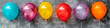 © Дмитрий Симаков - A bunch of balloons in various colors are hanging from a wall. The balloons are arranged in a row, with some being closer to the camera and others further away. Scene is festive and celebratory