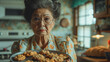 Elder woman offering cookies in kitchen