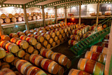Fototapeta Uliczki - French oak wooden barrels for aging red wine in underground cellar, Saint-Emilion wine making region picking, cru class Merlot or Cabernet Sauvignon red wine grapes, France, Bordeaux