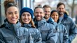 a group of participants in a corporate incentive program. All participants are wearing similar jackets
