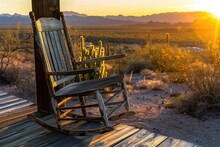 A Weathered Wooden Rocking Chair Sits On A Porch Overlooking A Vast Desert Landscape