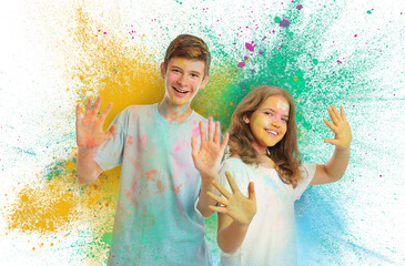 Wall Mural - Holi festival celebration. Happy teens covered with colorful powder dyes on white background