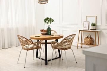 Canvas Print - Dining room interior with comfortable furniture and green branches