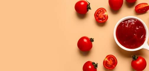 Wall Mural - Bowl with tomato paste and fresh vegetables on orange background