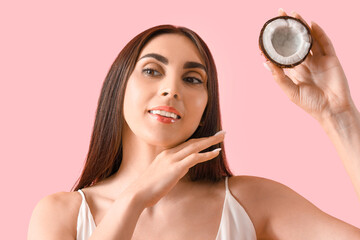 Canvas Print - Beautiful young woman with coconut on pink background, closeup