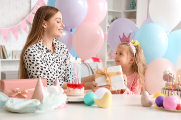 Sticker - Cute little girl in crown receiving Birthday gift from her mother at home