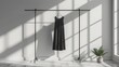 © Татьяна Креминская - Photograph a unisex dress hanging on a clothes rack, emphasizing the design's simplicity and elegance against a minimalist background