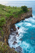 Cinematic aerial landscape shots of the beautiful island of Nusa Penida. Huge cliffs by the shoreline and hidden dream beaches with clear water and foaming wave.