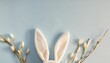 white rabbit ears on a light blue background with copy space easter minimalism