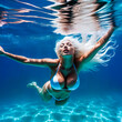 Woman Swimming Underwater.  Bikini Babe Swim in Clear Blue Water