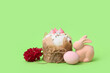 Easter cake, painted egg, bunny and hyacinth on green background, closeup