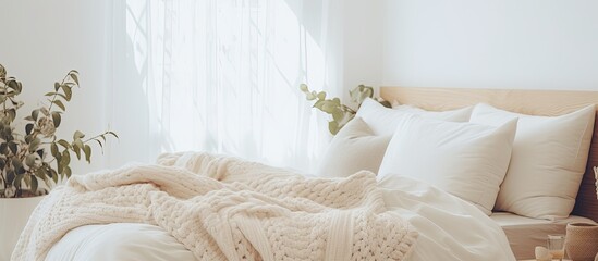 Wall Mural - A cozy bedroom with hardwood flooring, a bed with white linens and fur pillows, art on the wall, and a window with a view of twigs outside