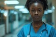 Portrait of a young female healthcare worker in scrubs at hospital